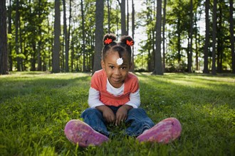 Black girl sitting in grass