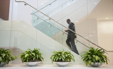 African American businessman ascending staircase