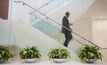 African American businessman descending staircase