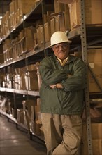 Mixed race man in hard-hat in warehouse