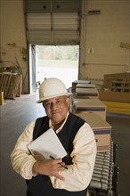Mixed race man in hard-hat in warehouse