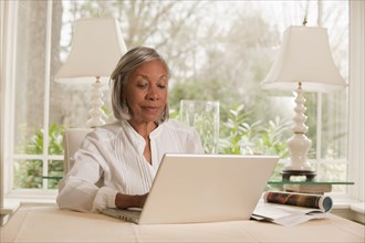 Black woman typing on laptop