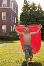 Caucasian boy playing with towel