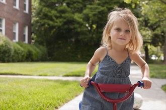 Caucasian girl riding bicycle