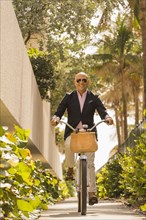 Caucasian businessman riding bicycle