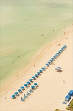 Aerial view of lawn chairs on beach
