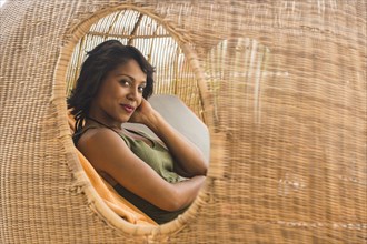 African American woman lounging in cabana