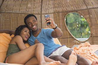 Couple taking selfie in cabana