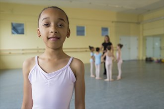Portrait of smiling girl in ballet studio