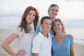 Caucasian family enjoying beach