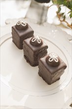 Three chocolate ganache petite cakes