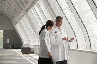 Doctors talking together in hospital corridor