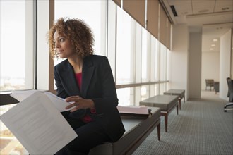 Mixed race businesswoman working in conference room