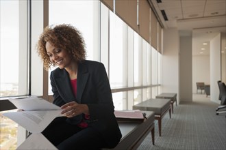 Mixed race businesswoman working in conference room