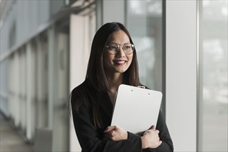 Asian businesswoman holding clipboard