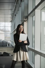 Asian businesswoman holding clipboard