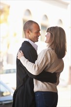 Caucasian couple hugging outdoors