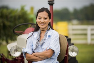 Asian woman smiling in field