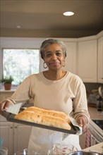 African American woman baking in kitchen