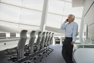Caucasian businessman on cell phone in conference room