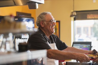 Hispanic server working in cafe