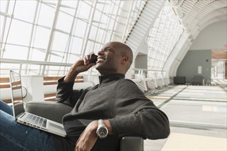 African American man on cell phone in lobby