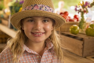 Mixed race girl smiling at farmers market
