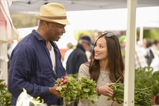 Couple shopping for produce at farmers market
