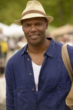 African American man wearing hat and tote bag