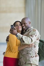 African American soldier and wife taking selfie