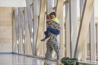 Returning soldier greeting girlfriend in airport
