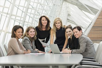 Businesswomen posing in conference room