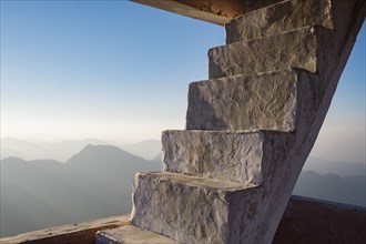 Concrete staircase overlooking scenic view of mountains
