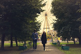Caucasian couple walking on path in park