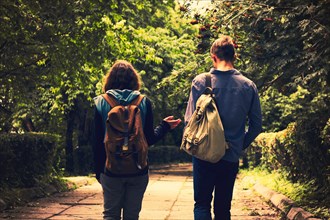 Caucasian couple walking together on path