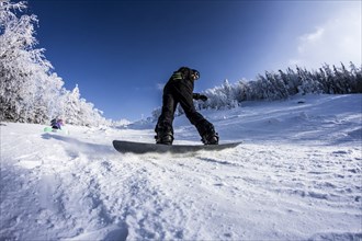 Caucasian snowboarder on snowy slope