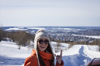 Caucasian woman gesturing on snowy road