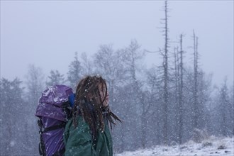 Caucasian hiker walking in snow