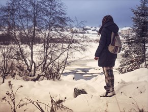 Caucasian woman admiring snowy rural scene