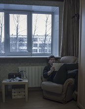 Caucasian man reading digital tablet in living room