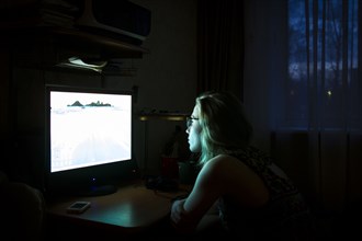 Caucasian woman using computer at night