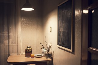 Food on corner table in kitchen with blackboard