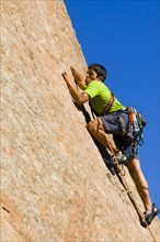 Hispanic man rock climbing