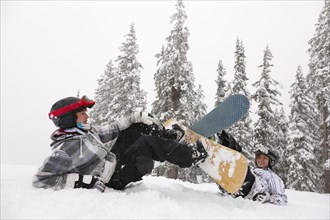 Snowboarders falling