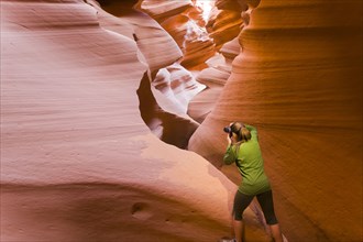 Persian woman taking photographs in canyon