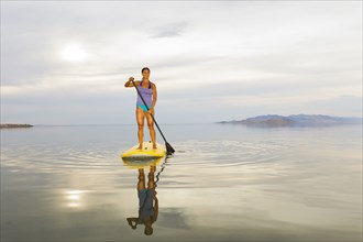 Filipino woman riding paddle board