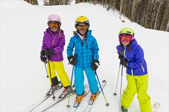 Girls skiing together on snowy slope