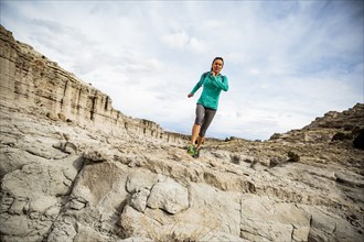 Woman running in canyon