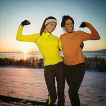 Runners posing and flexing muscles in winter