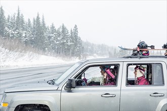 Friends driving in car in winter